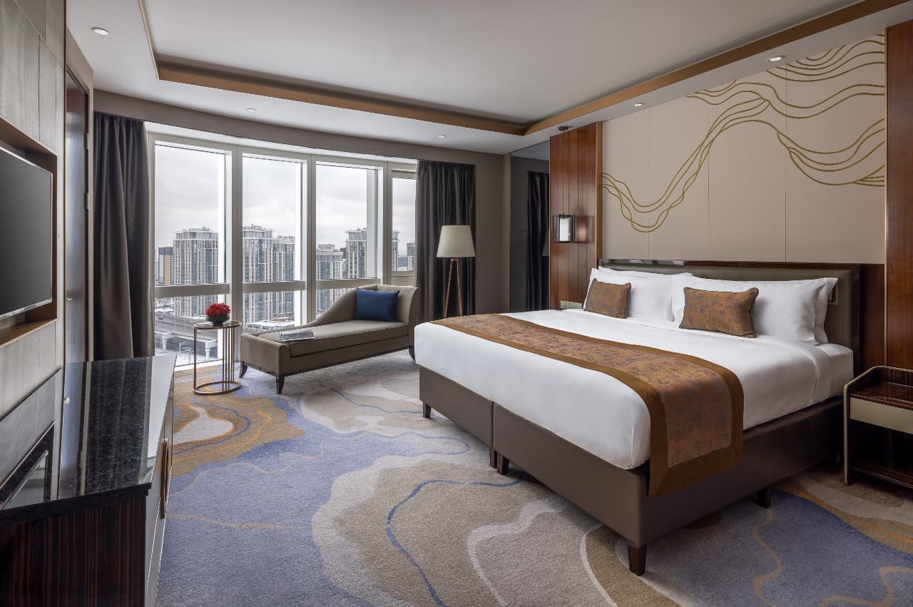 Lotus Suite bedroom with panoramic windows and a window seat